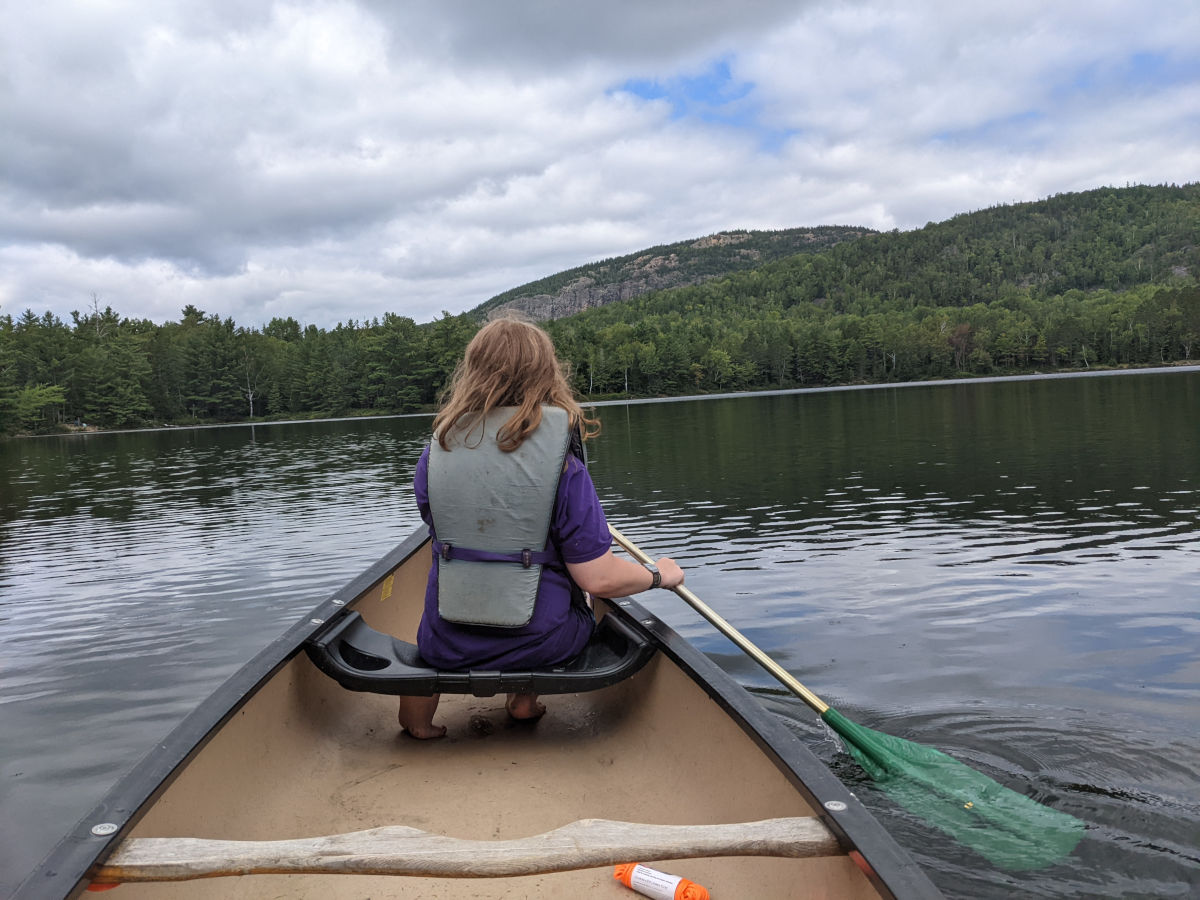 Fiona in the bow seat paddling in better weather