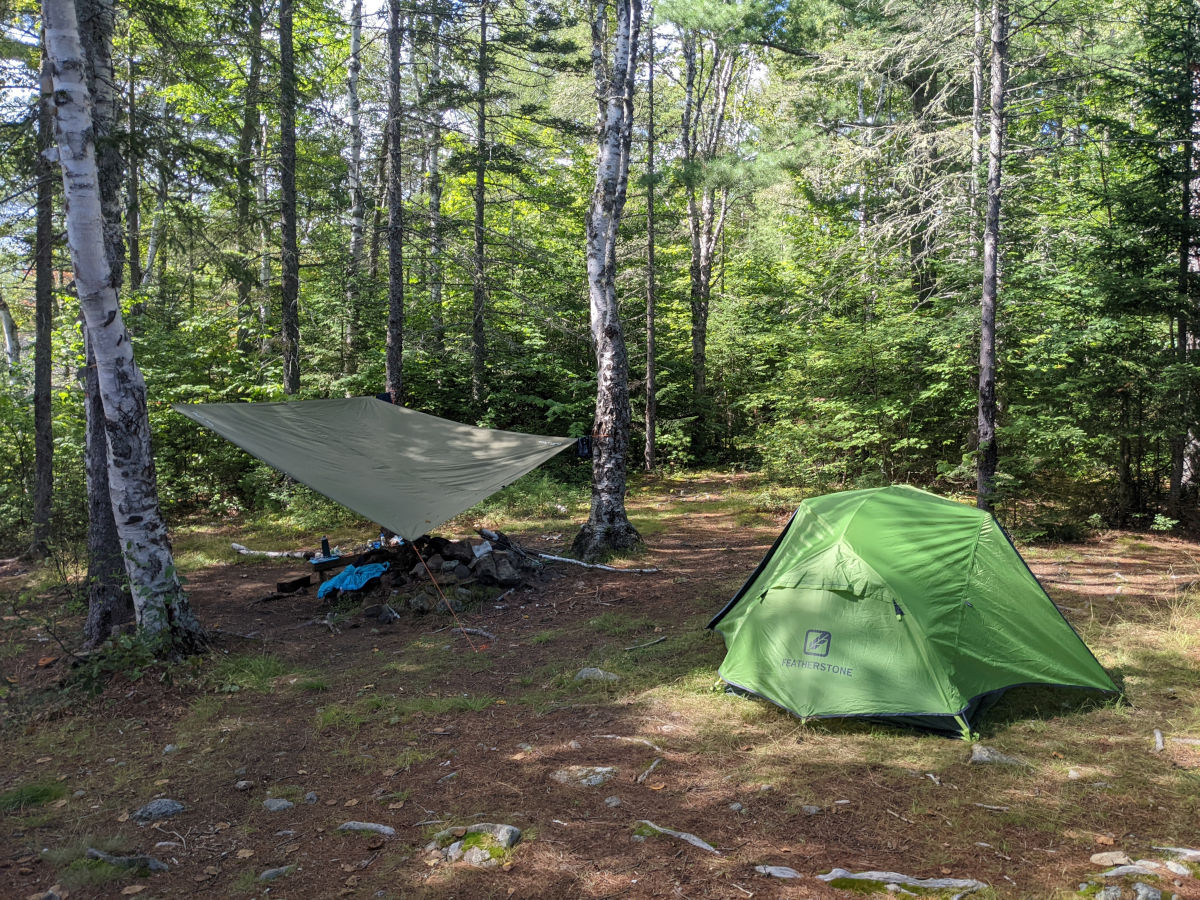 The tent on the right, tarp on the left