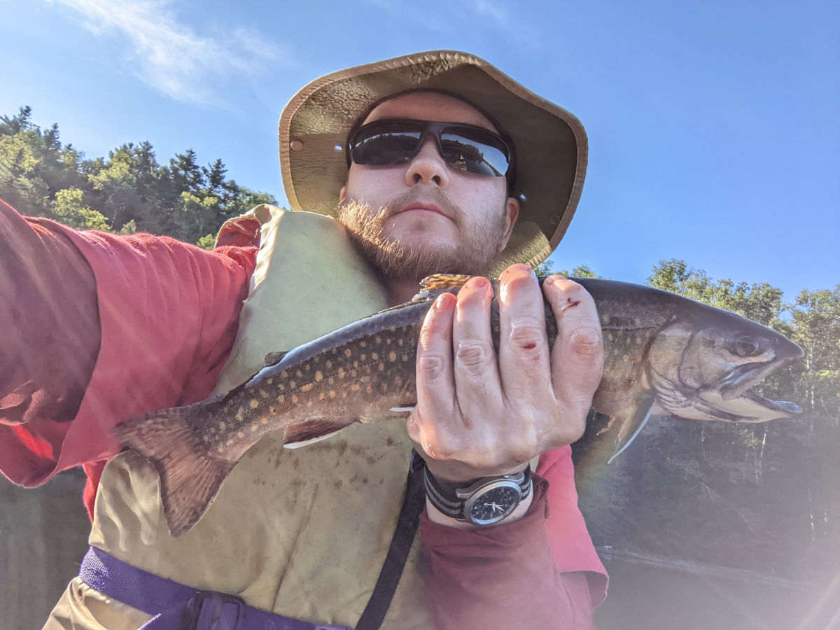 Me holding brook trout horizontally
