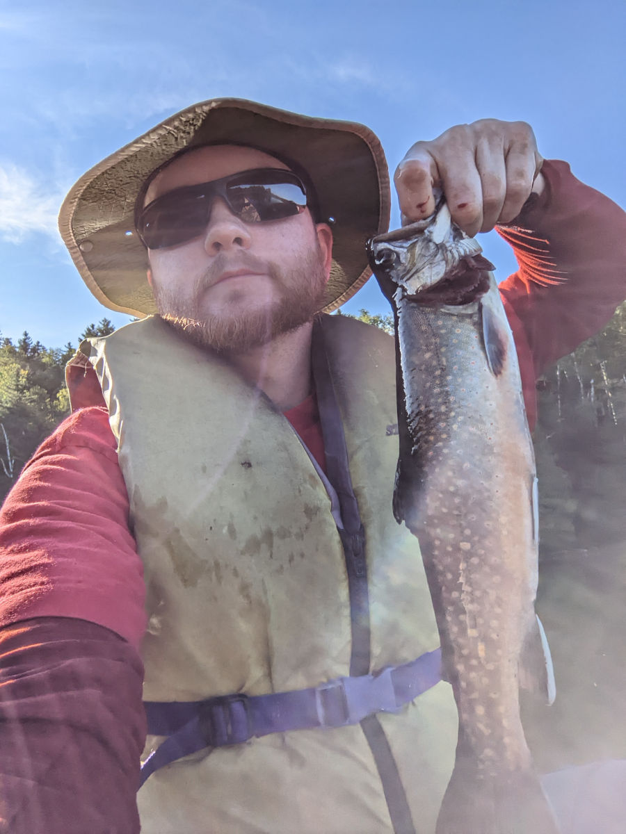 Me holding brook trout vertically