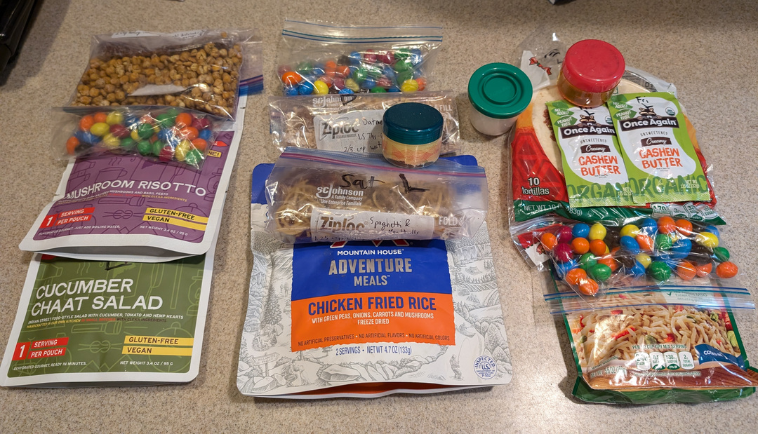 Three days of backpacking food laid out ready to be packed