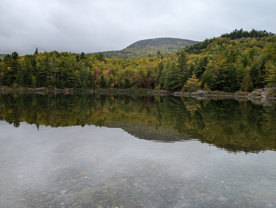 Smooth lake with mountain in the background