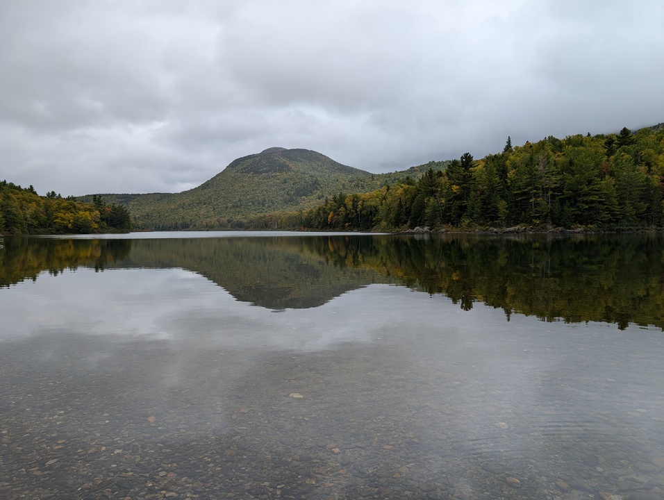 Smooth lake with mountain in the background