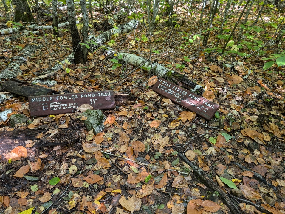 Signs for Middle Fowler Pond Trail on the ground