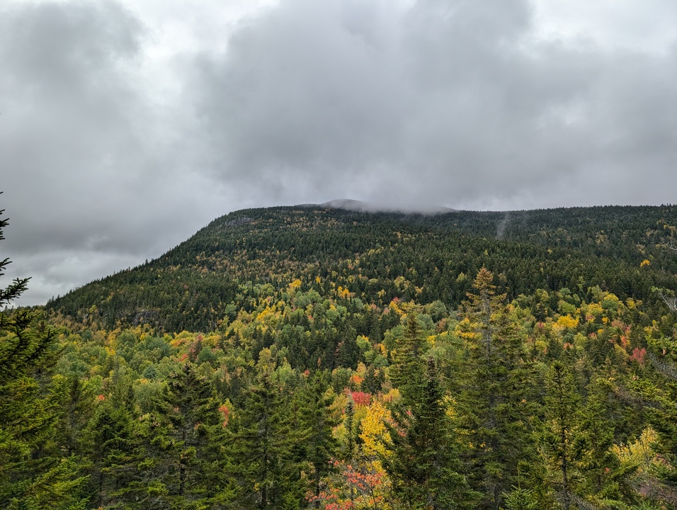 Mountain peak partially obscured by clouds