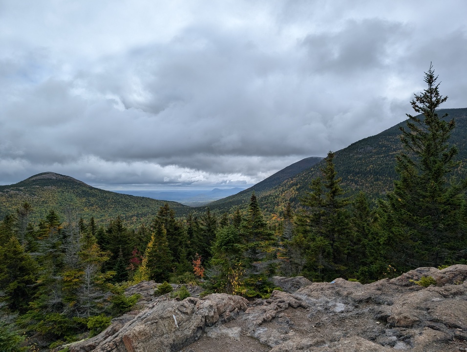 Three mountains nearby with more in the distance