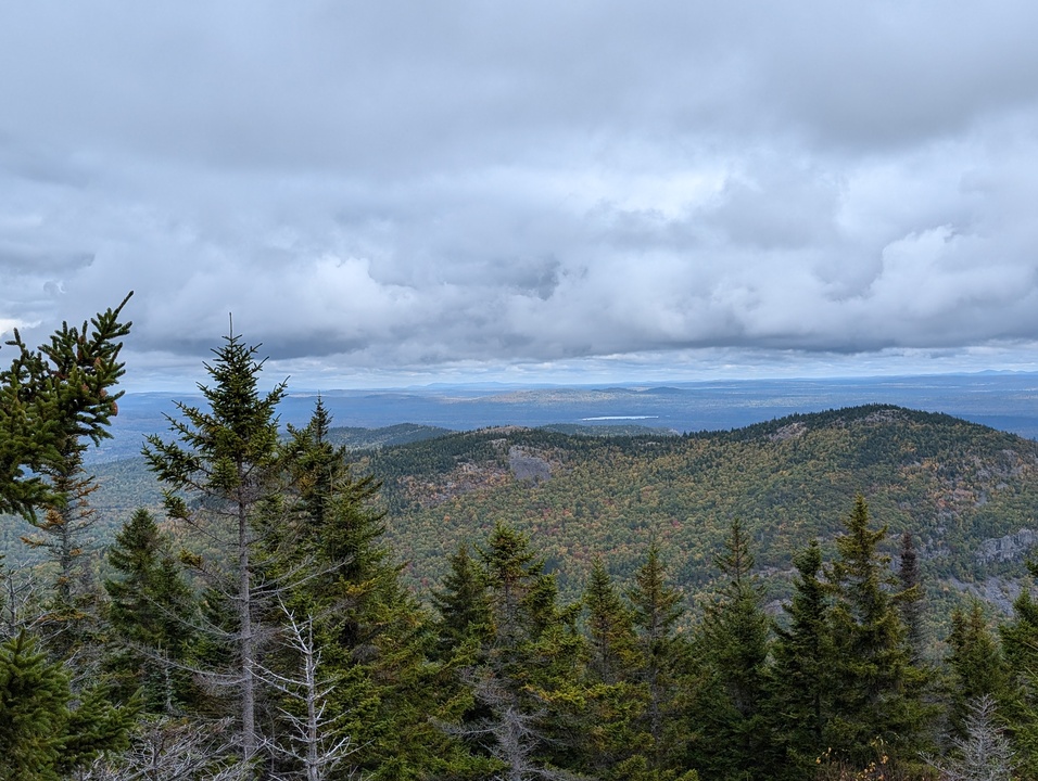 Distant lake barely visible over small mountain