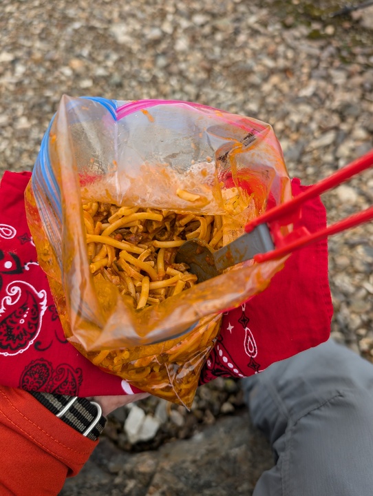 Rehydrated spaghetti and meatballs in a Ziploc bag with a spoon