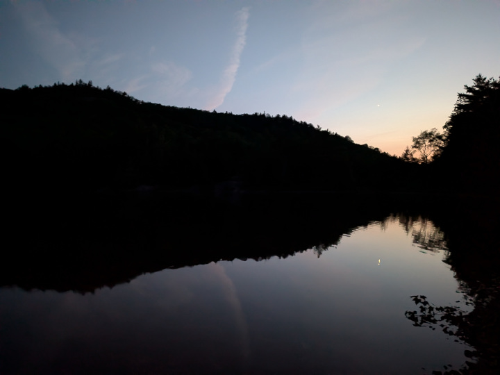 Tree silhoutes reflected on Middle Fowler Pond at sunset