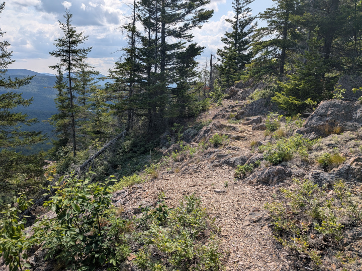 Trail continueing on with dropoff to the left