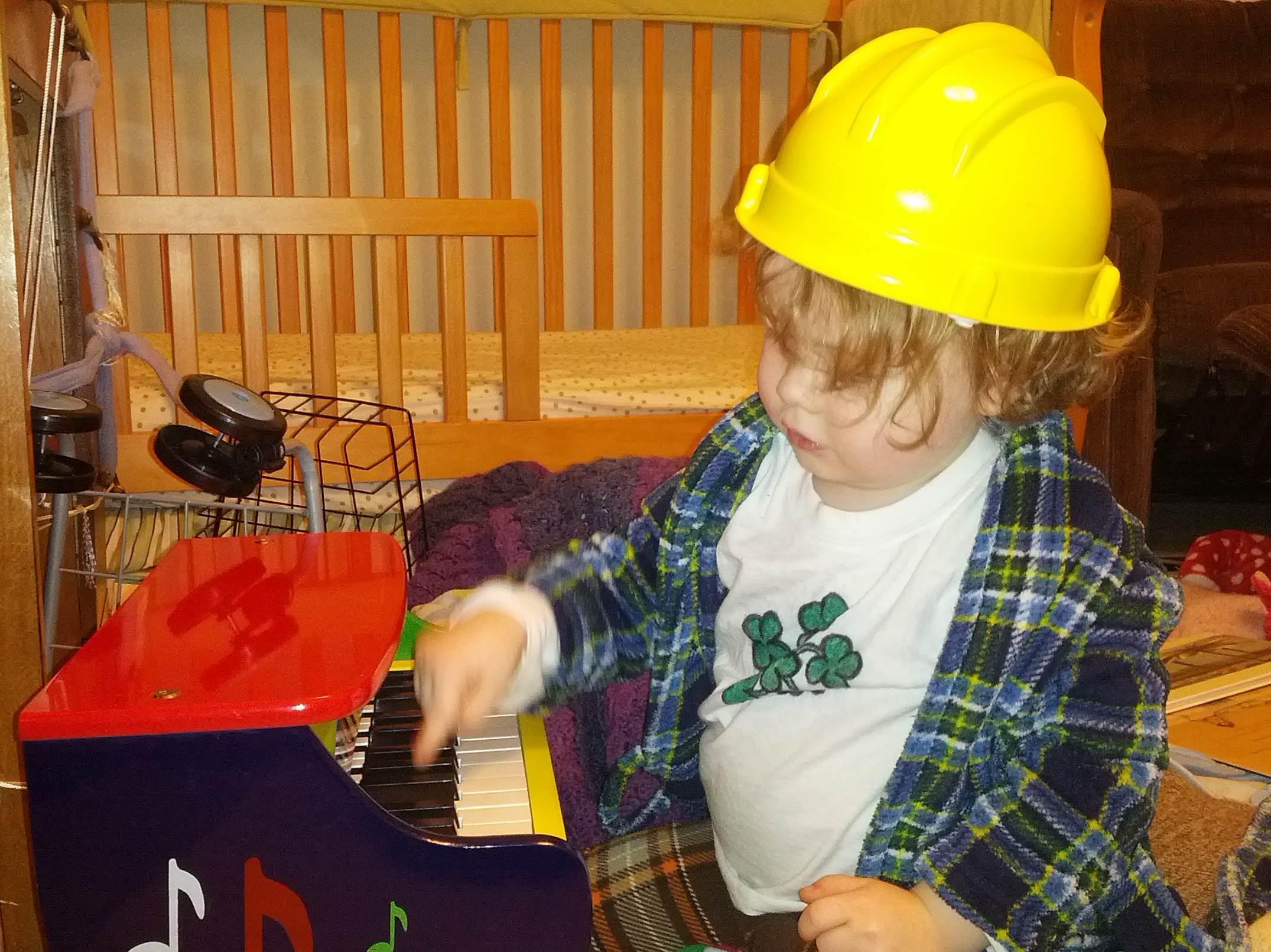 Wearing a hardhat and robe to play the piano